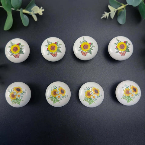 Kick Up Your Rustic Style With Eight Darn Cute Ceramic Kitchen Cabinet Drawer Knobs Featuring Pretty Sunflower And Butterfly Art For Dressers And Cupboards Designed For Smooth Grip Easy Install And Farmhouse Vibes - Set of eight glossy ceramic knobs with floral designs.