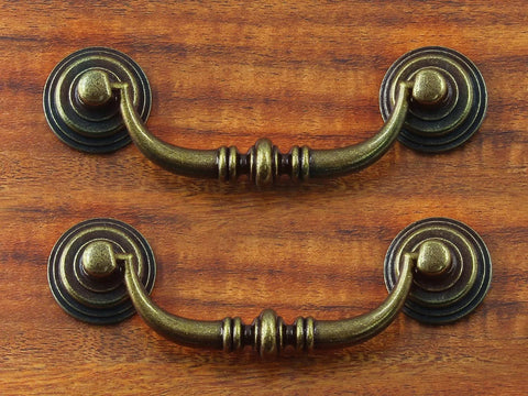 Antique Drop Bail Drawer Pulls 4.5 Inch Long 88mm Center To Center 3.5 Inch Vintage Bronze Cabinet Pull Handles on wood surface