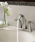 Eva Brushed Nickel Two-Handle 4-Inch Centerset Bathroom Faucet with Drain Assembly, installed on a 3-hole sink.