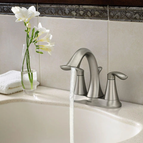 Eva Brushed Nickel Two-Handle 4-Inch Centerset Bathroom Faucet with Drain Assembly, installed on a 3-hole sink.