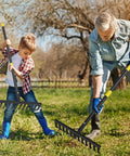 Father and son using Heavy Duty Garden Rake With 78 Inch Handle And Twisted Tooth Tines for lawn maintenance in backyard.
