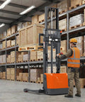 3300 Lbs Full Electric Walkie Stacker Material Lift With Straddle Legs and Adjustable Forks Up To 98 Inches Max Lifting Height in warehouse.
