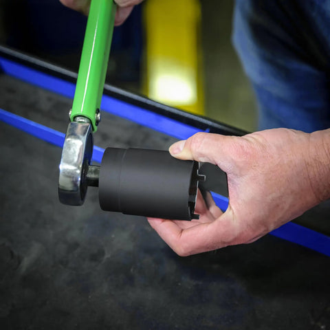 Mechanic using Dana 44 Lug Nut Spindle Socket Heavy Duty Tool Built For 4WD Dana 44 Axles Only Works With GM Dodge And Select Ford Applications Ideal For Mechanics And Off Roaders Needing Quick Nut Access And Replacements on vehicle axle.