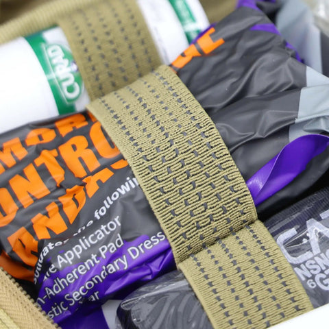Close-up of medical supplies in Rip Away Officer's Patrol Tactical Gunshot And Trauma IFAK Kit With Headrest Mount Desert Tan.