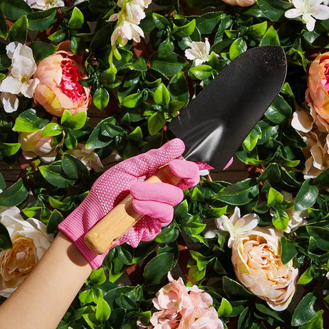 Person wearing pink Women's Garden Gloves Set, 6 Pairs, Thorn Proof And Cut Resistant, Breathable Cotton With Enhanced Grip holding trowel.