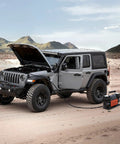 Heavy Duty Dual Cylinder Air Compressor Packed With 10.6 Cfm Quick Fill And Auto Shutoff next to a Jeep in a desert setting.