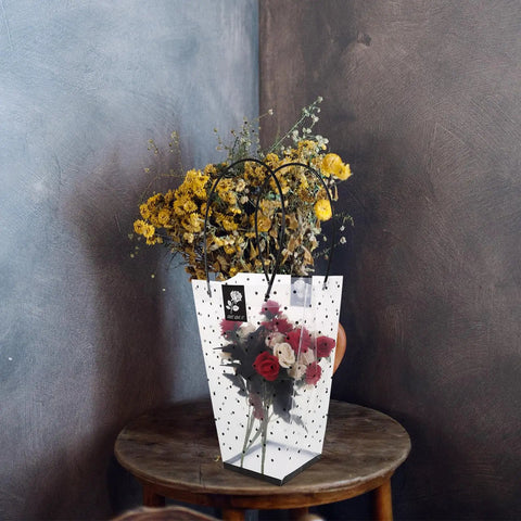 Plastic Flower Bouquet Bag With Handle For Floral Arrangements And Weddings on a wooden table