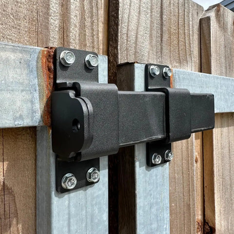 Heavy Duty Tough As Nails Slide Gate Latch Lock With Padlock Hole for Wooden Fences attached to metal gate frame, matte black hardware