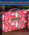 KeepGoing travel first aid kit bag, red patterned nylon with medical icons and brown logo patch; pink zip pouch nearby.