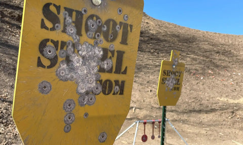 Half Inch AR500 Steel Target Silhouette 12 By 20 Inch with bullet impacts in a shooting range setup for rifle practice
