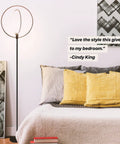 Torchiere-Style No-Fuss Dimmable LED Floor Lamp For Living Rooms And Offices with black frame in bedroom setting