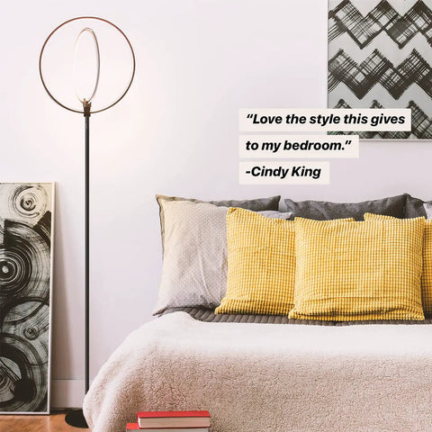 Torchiere-Style No-Fuss Dimmable LED Floor Lamp For Living Rooms And Offices with black frame in bedroom setting
