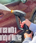 Using Short Pressure Washer Gun 3600 Max PSI With M22 Connector spraying foam on car panel, focus on gun and spray action.