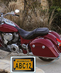 Red motorcycle with Badass Matte Black Stainless Steel Motorcycle License Plate Frame With Heavy Duty Tag Holder attached.