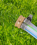 Close-up of Garden Hose Repair Kit with clamps and fittings for 3/4 or 5/8 inch hoses featuring stainless clamps on grass.