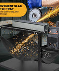 Beefy Plasma Cutting Table For Heavy Duty Workshops 32 In High By 21 In Wide By 30 In Long Carbon Steel Workbench With Replaceable Slats Folding Side Shelf Fire Resistant Scrap Tray 250 Lbs Load Capacity, showing slag catch tray in use.
