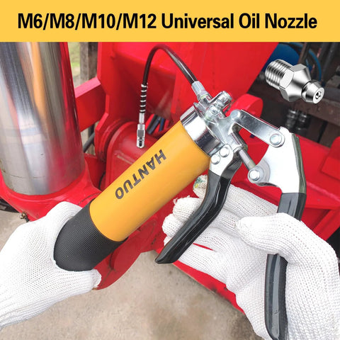 Close-up of yellow pistol-grip grease gun with quick-release coupler and 90° adapter.