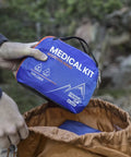 Person holding Mountain Series Explorer Outdoor Expedition Grade Emergency First Aid Kit For Four Adventurers Seven Days