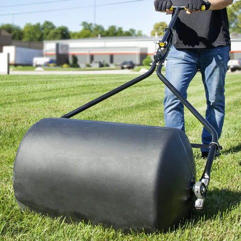 Person using Spyker 300lb Push Tow Commercial Lawn Roller With No Tools Handle on grass