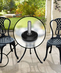 Heavy Duty Adjustable Furniture Levelers 8 Pack Weatherproof Screw In Leg Glides For Patio Chairs Built Badass To Kick The Wobble Smooth PTFE Slider Feet installed on black chair legs in outdoor setting.