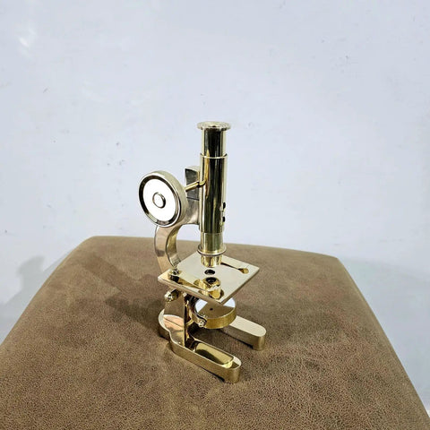 Top Shelf Handmade Solid Brass Microscope With Adjustable Focus Knob Straight Fire Vintage Desktop Display on brown leather surface.