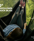 Person relaxing in 12ft Lightweight Hammock Bug Net for Camping, Easy Setup, Ultra Breathable 360 Degree Coverage, outdoors scene.