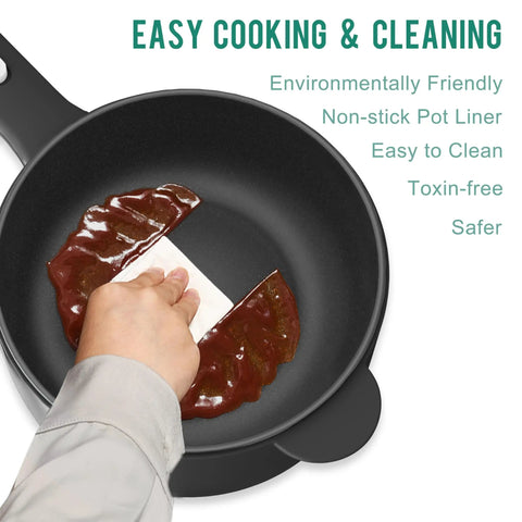 Hand wiping nonstick 2L Mini Electric Pot with Sauté and Steam Function, highlighting easy cleaning feature, black interior.