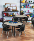 Adjustable Table Legs Set Of 4 In Black And Chrome, Heavy Duty Post Legs For Wood Desks And Tables, Adjusts From 22 To 33 Inches in a classroom setting with children’s tables and toys.