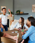 Group of four playing Total Kick Back Uno Card Game For Weekend Hangouts, enjoying fun in a cozy living room.