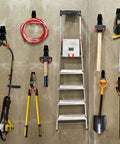 Garage with 12 Pack Heavy Duty Garage Wall Hooks With Extension Cord Straps, holding various tools and a ladder, in orange.