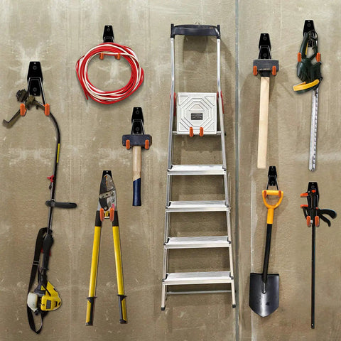 Garage with 12 Pack Heavy Duty Garage Wall Hooks With Extension Cord Straps, holding various tools and a ladder, in orange.