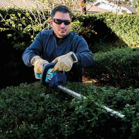 Man using 18V LXT Cordless Hedge Trimmer With 24 Inch Dual Action Blade Tool Only No Gas No Mess No Emissions Or Oil Mixing