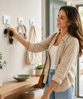 Woman using Heavy Duty Adhesive Hooks With 360 Degree Swivel Nail Free Wall Ceiling Mount Rotating Rack for keys.