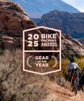 Cyclist riding on rocky trail with desert mountains, showcasing Ultra Lite Outdoor Bathroom Kit for Hiking, Trail Running, Mountain Biking, and Bikepacking.