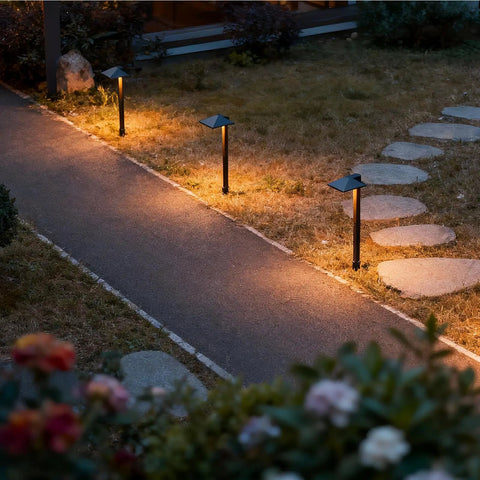4 Pack 12V Outdoor Landscape Pathway Lighting Kit With 0.6W LED, 3100K Warm White, black aluminum lights lining a garden path