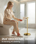 Heavy Duty Freestanding Toilet Paper Holder Stand In Matte Gold Frame Delivers Rock Solid Stability And Non Slip Floor Cushion For Slick Bathroom Upgrades And Hassle Free Roll Swaps with a woman reaching for paper.