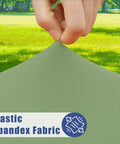 Close-up of stretchy sage green picnic table cover being stretched, highlighting elastic spandex fabric