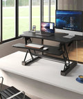 Standing Desk Converter 48 Inch Wide Sit Stand Desk Riser With Dual Gas Spring Handles, height adjustable on desk with monitors