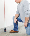 Person using Super Handy 165 Foot Blaze Laser Distance Measure with Backlit Color Display in indoor setting, showing accuracy in any lighting condition.