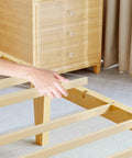Natural Bamboo King Size Platform Bed Frame With Headboard, showing hand adjusting frame slats for support.