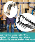 Tough As Nails Adjustable Dust Collection Hose Hangers And Pipe Wall Mounts, Flexible Clips For Shop Vacuums And Power Tools, Heavy Duty Black Brackets With 2.5 Inch Grip, Five Piece Workshop Kit on workbench.