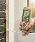 Heavy Duty Expanding Polyurethane Spray Foam 17 Oz Multi Purpose Gap Filler applied to window frame for insulation.