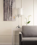 Moiselle Swanky Modern Table Lamp With Chrome Finish, Double Drum Shade In Sheer Off White, on side table in living room