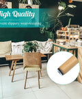 24 Pack Screw On Furniture Sliders For Heavy Gear 1 Inch Square Floor Glides on a chair leg in a cozy cafe setting.