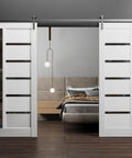 Sturdy Double Barn Door Kit With White Silk Panels And Black Glass, 72x96 Inches, installed in a modern bedroom interior.