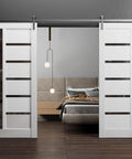 Built Tough Double Barn Door Set Featuring Dead Easy 13 Foot Stainless Steel Rail Hardware With Slick Glide Action Alongside Silk Finish White Panels And Deep Black Glass Trims For Rapid Living Space Upgrade, installed in modern interior.
