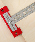 Heavy Duty Scriber T Square Ruler With Support Lips And Built In Scribe Notches Crafted From Rock Solid 301 Stainless Steel Plus Sturdy Aluminum Handle To Nail Every Carpenter Layout Job And Architectural Plan 12 Inch displayed on plywood.