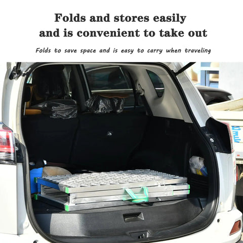 Heavy Duty Folding Scaffold Tower With Adjustable Height And Non Slip Deck Built Like A Tank loaded in car trunk for easy transport.