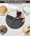 Super Strong 4x6 Rug Gripper Pad being cut to fit, suitable for laminate, tile, vinyl, and hardwood floors, non-slip design.