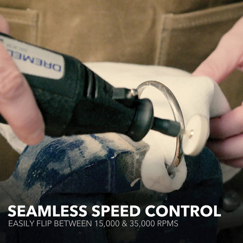 Person using Two Speed Corded Rotary Tool Kit With 15 Accessories at 15000 or 35000 RPM for crafting.